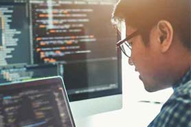 Man looking at software code