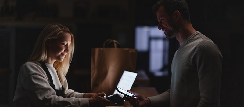 Man and woman checking their devices