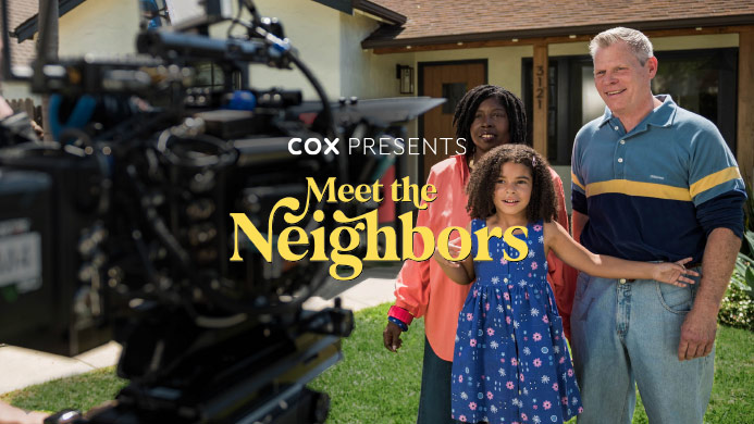 family-of-three-standing-on-front-lawn-in-front-of-house-with-tv-cameras-shooting-a-commercial-of-them-and-overlay-of-cox-presents-meet-the-neighbors-text