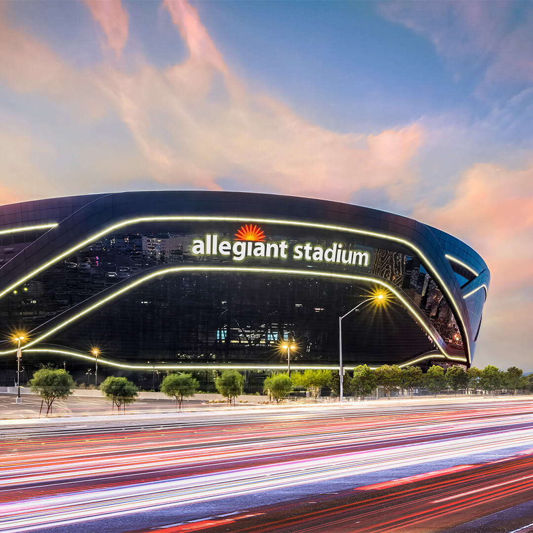 Allegiant Stadium lit up with lights passing at fiber speed