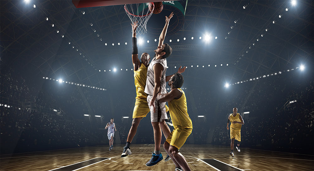 basketball players jumping for ball