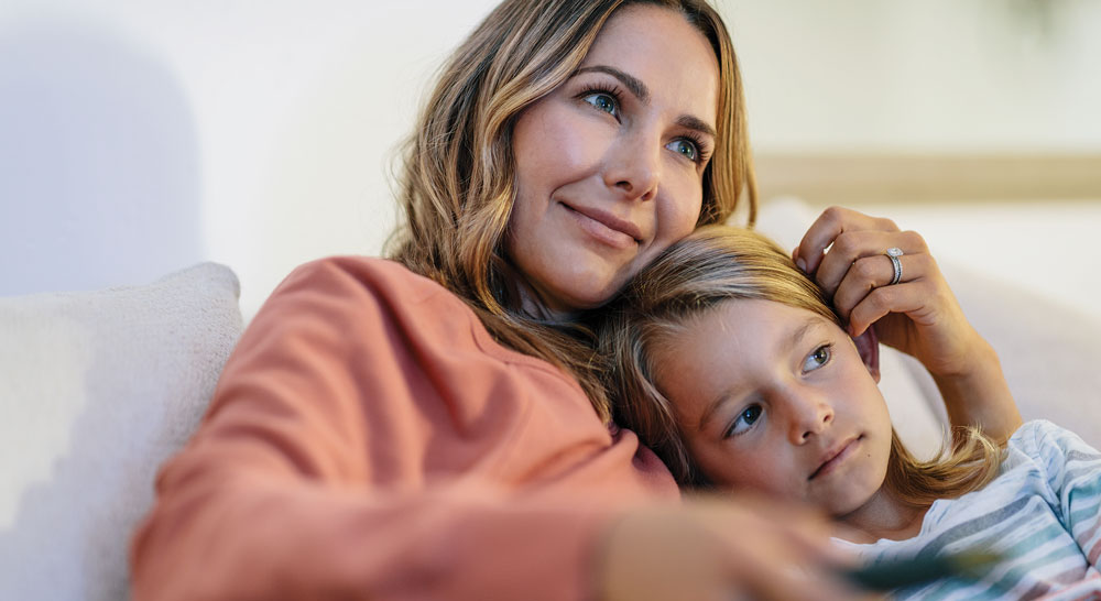 mother watching tv with child