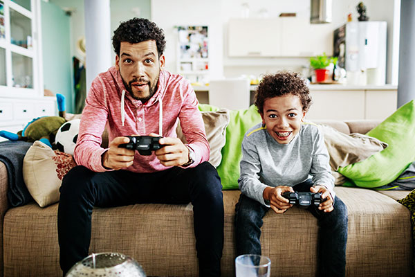 dad-and-son-on-couch-using-game-controllers
